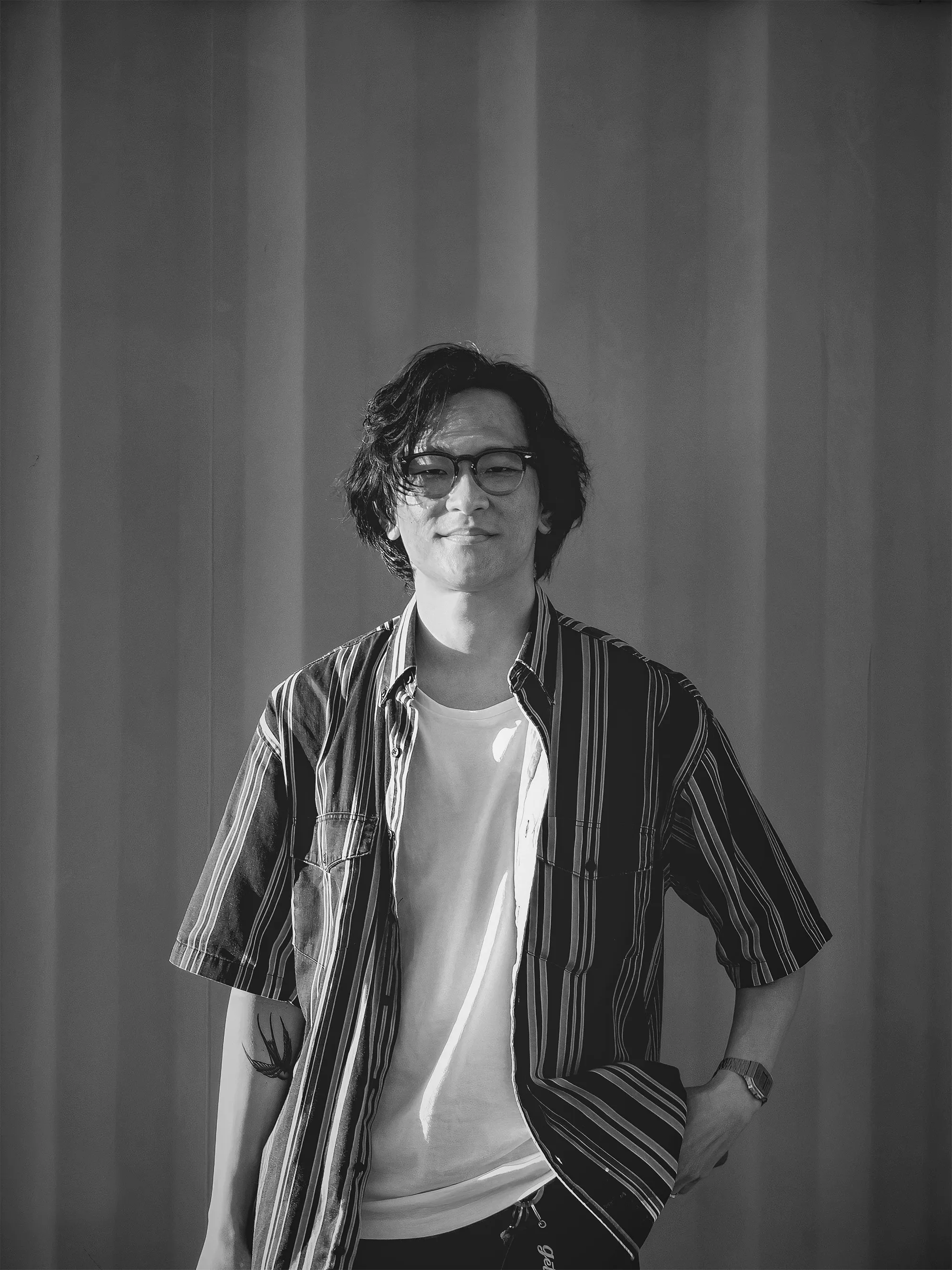 A portrait of Calvin Lau in black and white.